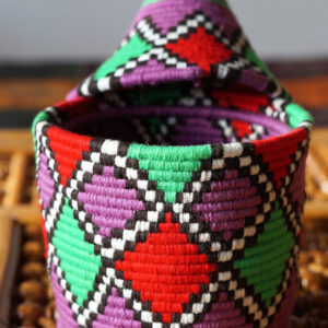 Purple Berber from Morocco. Straw, wool, and Raphia fabrics  used to create this hand-embroidered basket.Berber basket in original form.